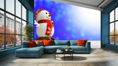 christmas and new year`s sale background with snowmen slides on blue holiday bokeh lights. foregroun Wall mural